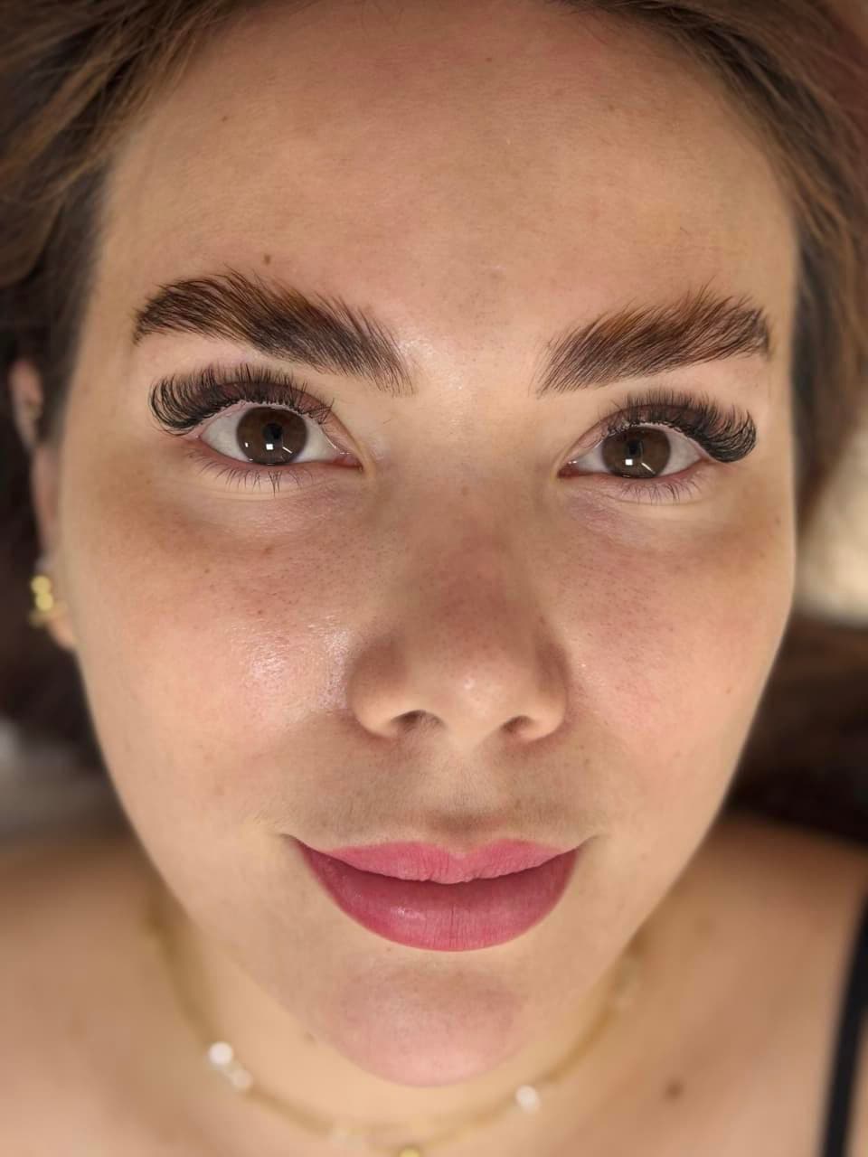 Semi-volume lash extensions and shaped brows in a full-face close-up