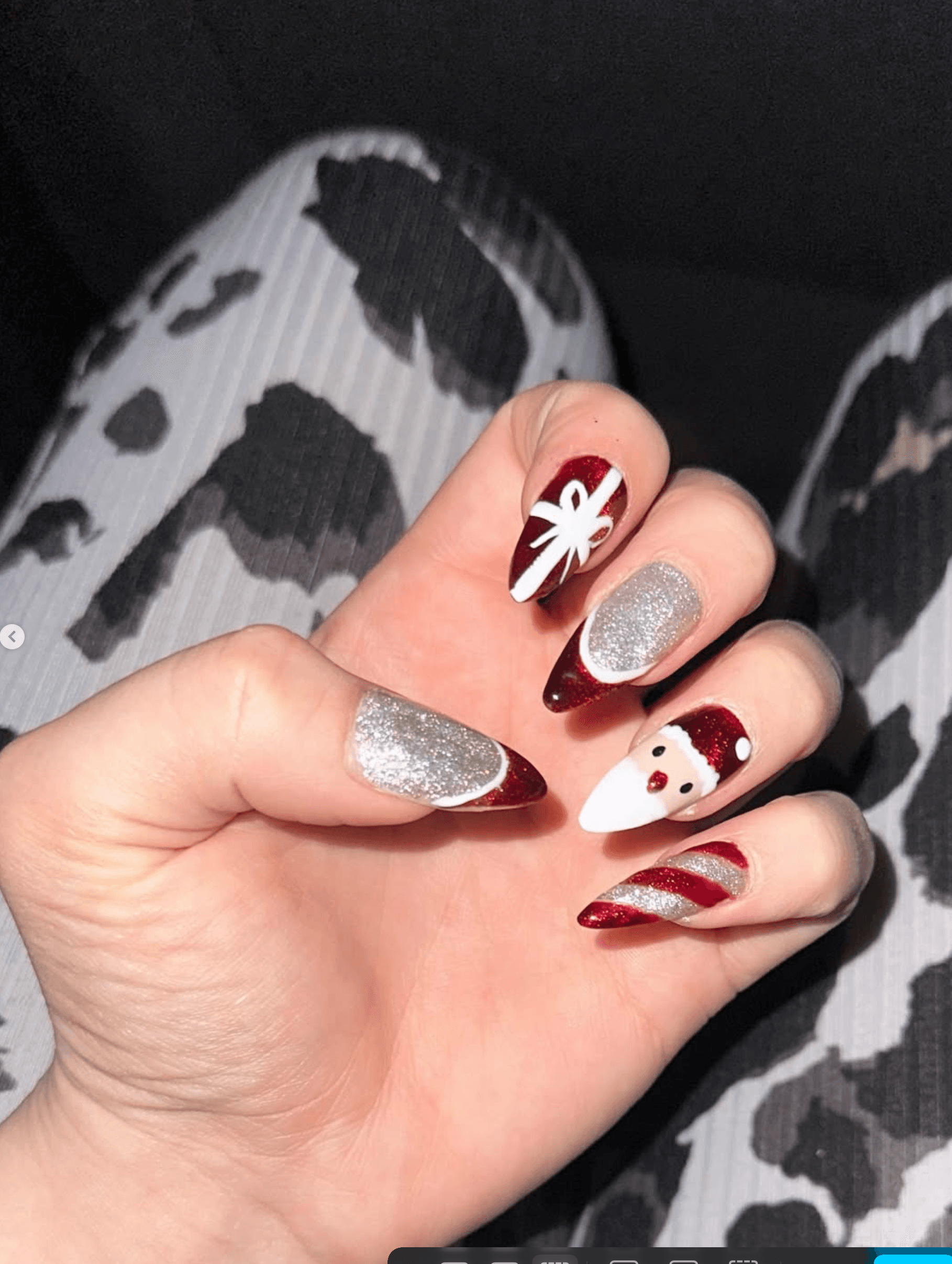 Christmas nail art with Santa Claus and glitter on almond acrylic nails