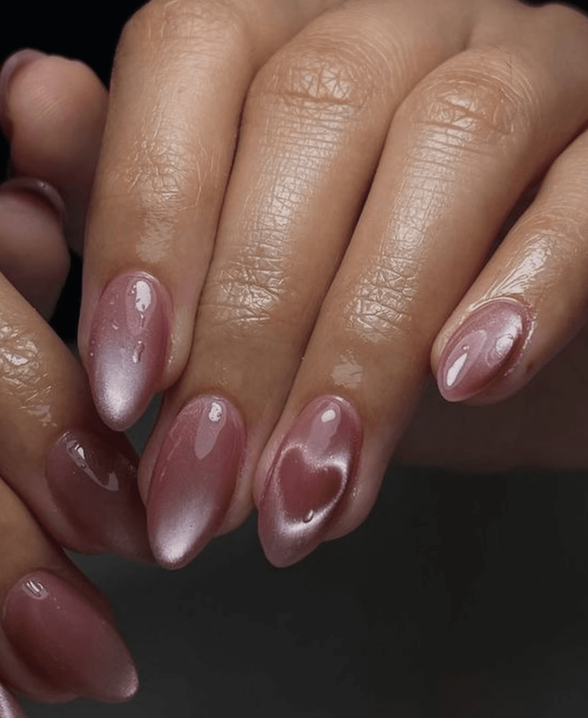 Almond nails in mauve aurora finish with a pearlescent heart accent