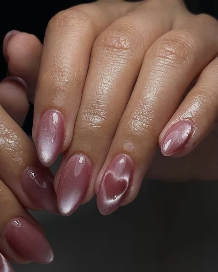 Mauve nails with purple cat-eye and a crystal heart on the accent nail
