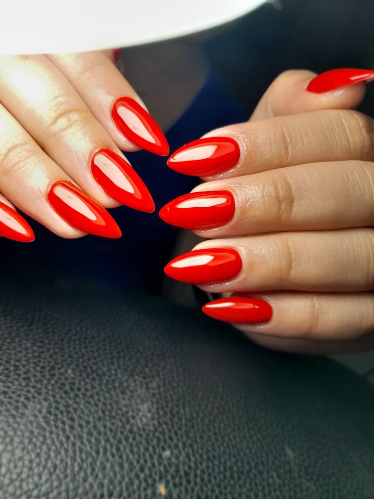 Classic red almond nails with a flawless high-gloss finish