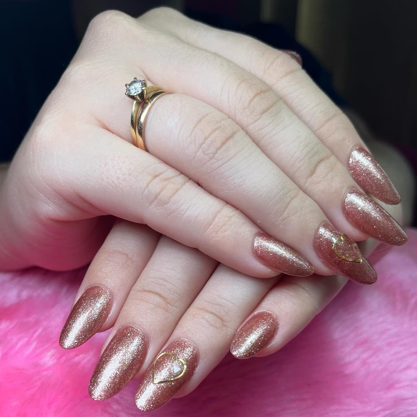 Rose gold almond nails with subtle glitter in a gradient effect